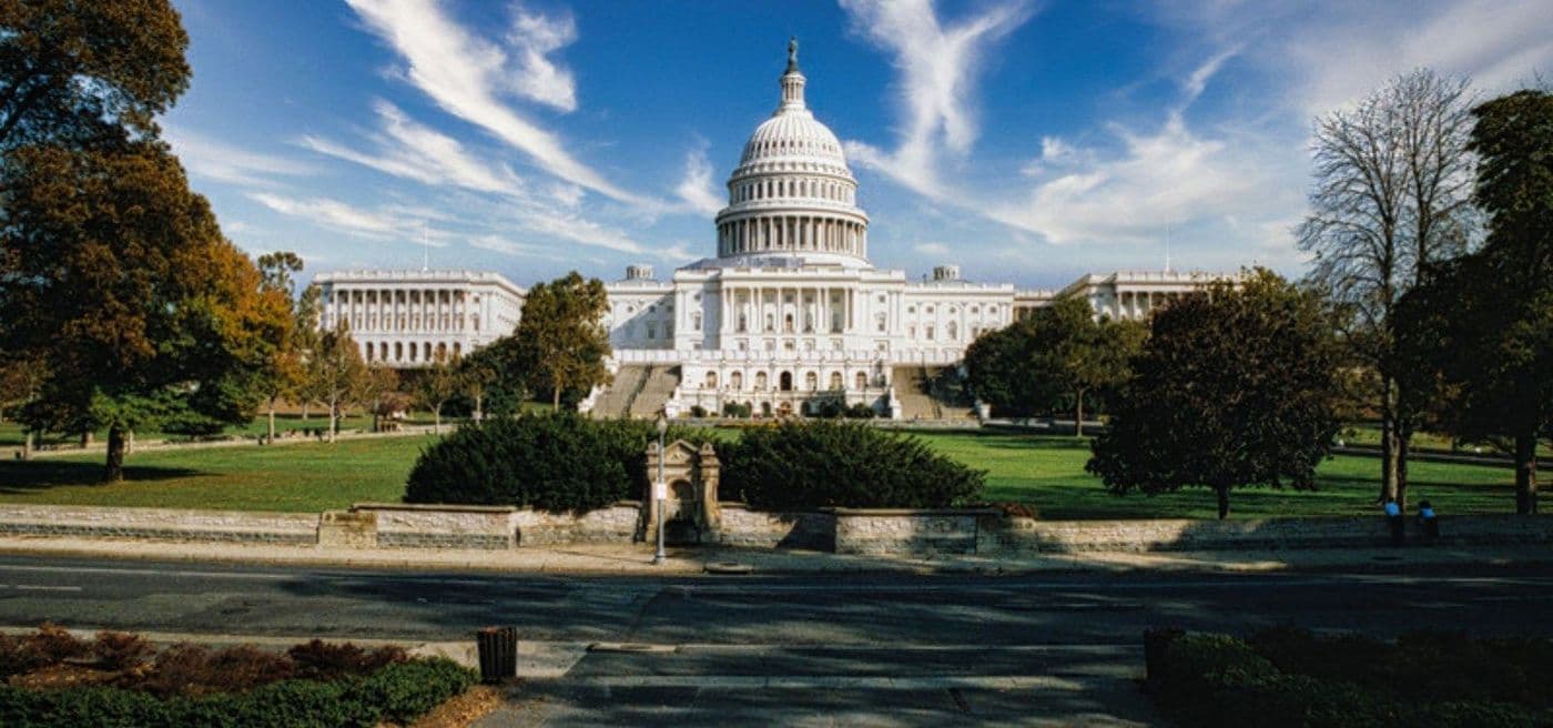 The west front of the U.S. Capitol seen across the lawn from the National Mall.
